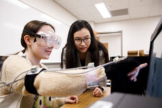 Two female students work together on project